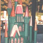 This was created for a large Golf Tournament at Piper's Landing in Stuart FL in 1995 with a "Wizard of Oz" theme.  the castle was made out of a styrene material and  would light up on the inside, covered in fondant, the actual cake was large sheet cakes covered in clouds below the castle.  